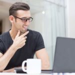 man with coffee and laptop