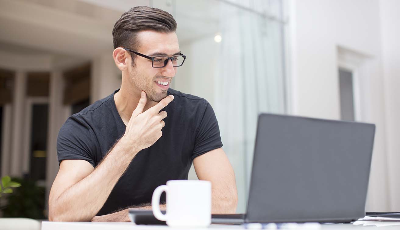 man with coffee and laptop